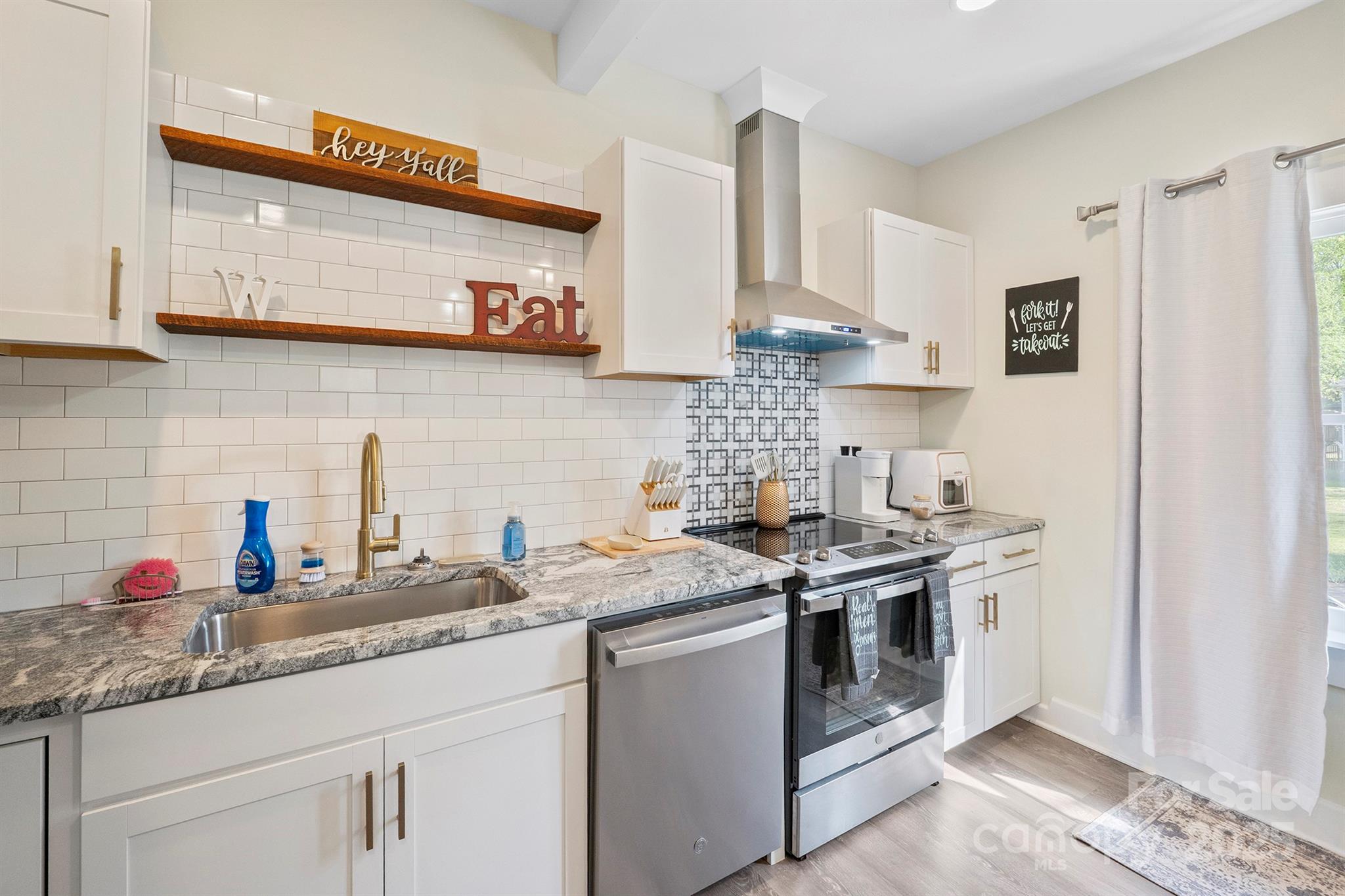 600 3rd Street Spencer, NC 28159 - Photo 5 of 27 a kitchen with stainless steel appliances granite countertop a stove and a sink