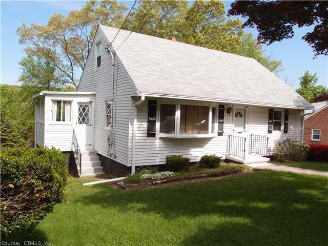 a front view of a house with a yard porch and outdoor seating