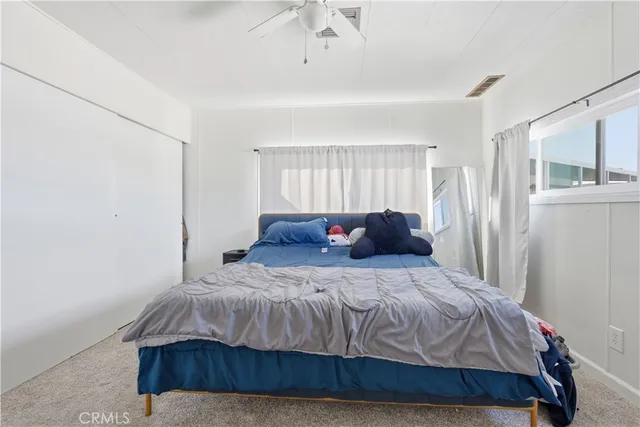 a bedroom with a bed and window