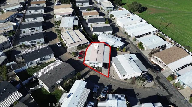 an aerial view of a city with lots of residential buildings and parking space