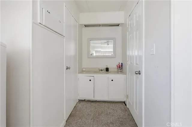 a bathroom with a granite countertop sink mirror and toilet