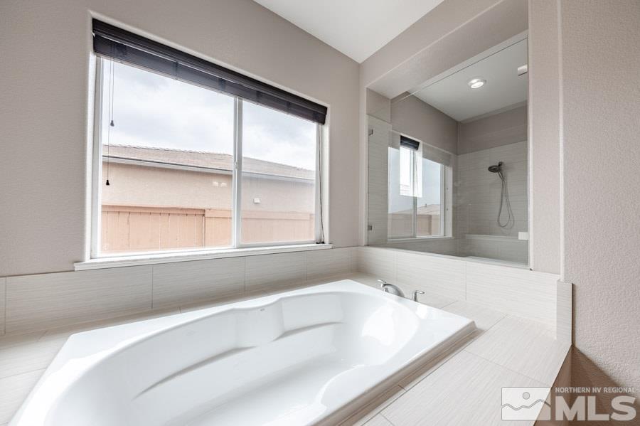 9875 Firefoot Lane Reno, NV 89521 - Photo 18 of 29 a bathroom with a bathtub and a window