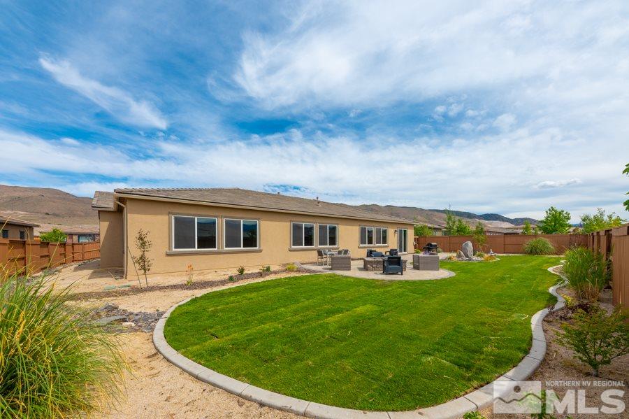 9875 Firefoot Lane Reno, NV 89521 - Photo 23 of 29 a view of a house with a backyard porch and sitting area