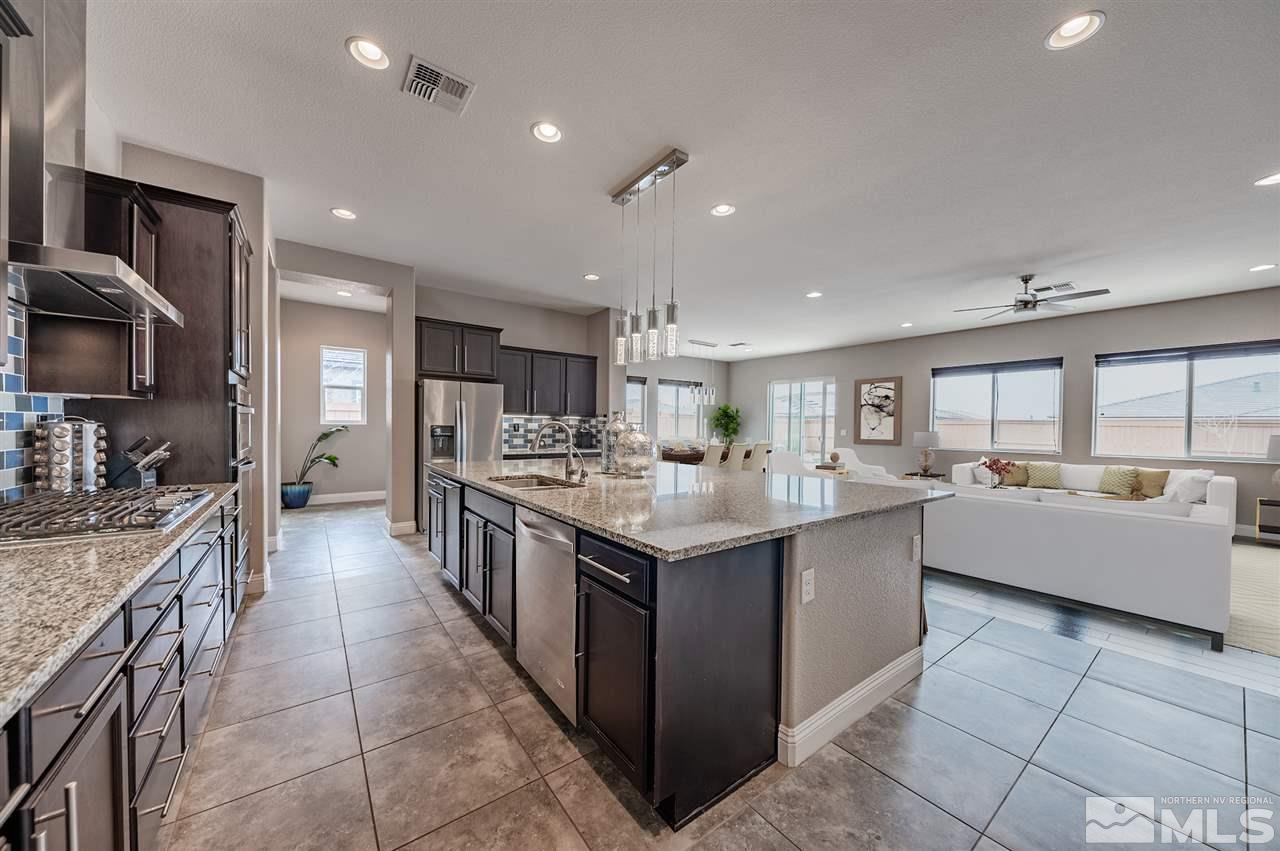 9875 Firefoot Lane Reno, NV 89521 - Photo 9 of 29 a large kitchen with stainless steel appliances granite countertop a large counter top and a stove