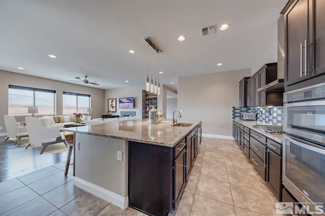 9875 Firefoot Lane Reno, NV 89521 - Photo 10 of 29 a kitchen with kitchen island granite countertop a sink counter top space appliances and a center island