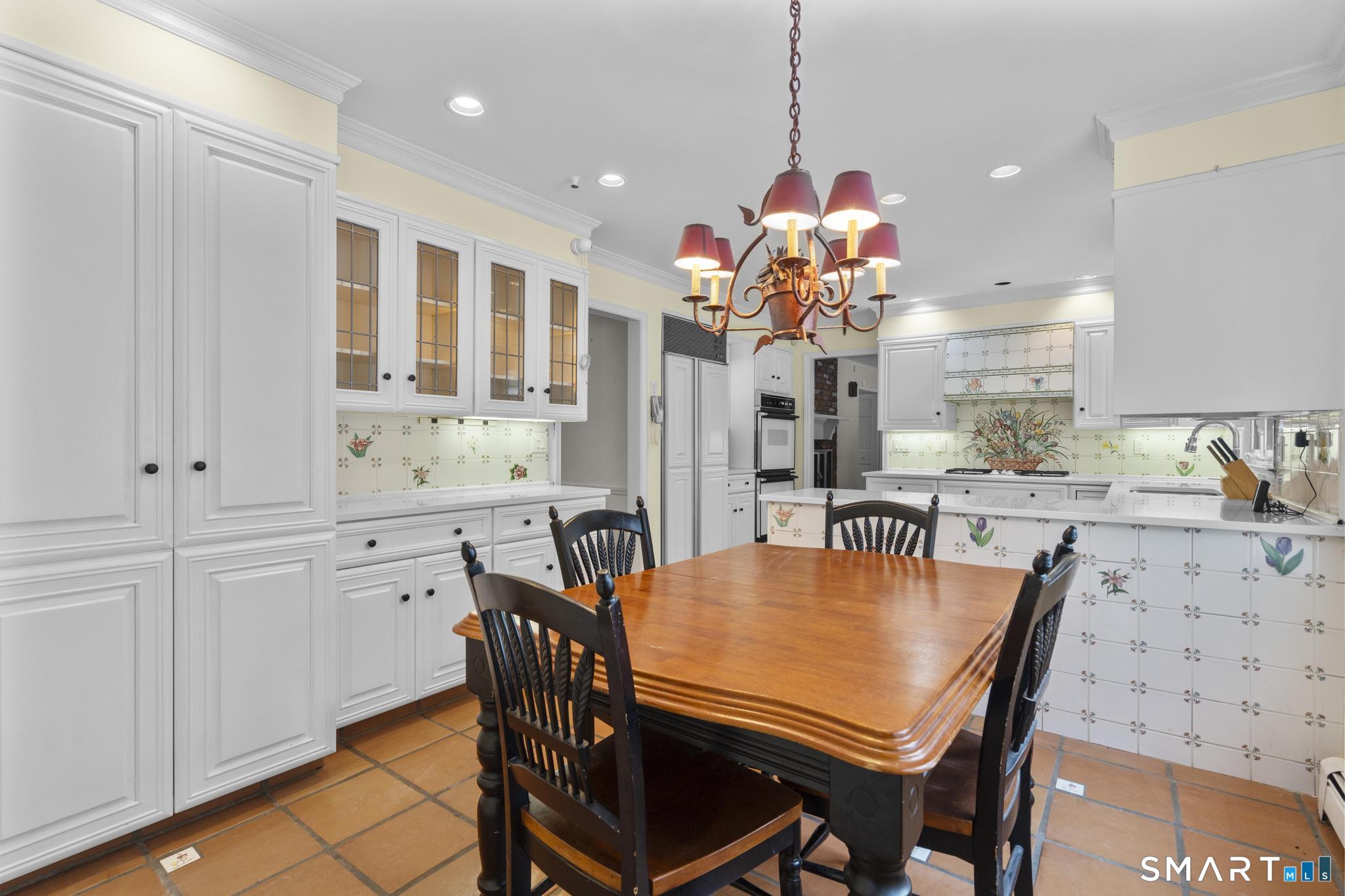 4 Twist Hill Road Newtown, CT 06470 - Photo 11 of 40 a dining room filled chandelier and kitchen view