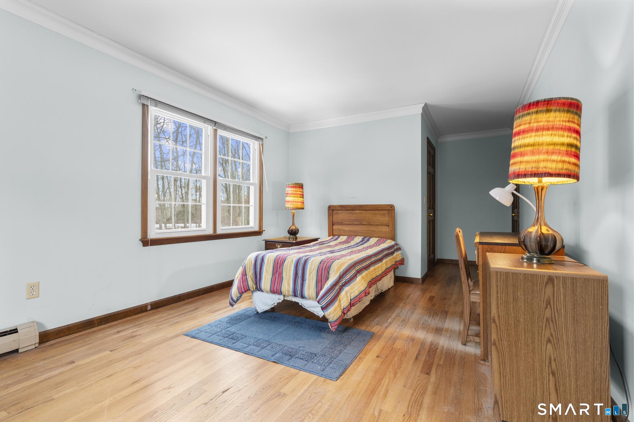 4 Twist Hill Road Newtown, CT 06470 - Photo 17 of 40 a bedroom with a bed and wooden floor