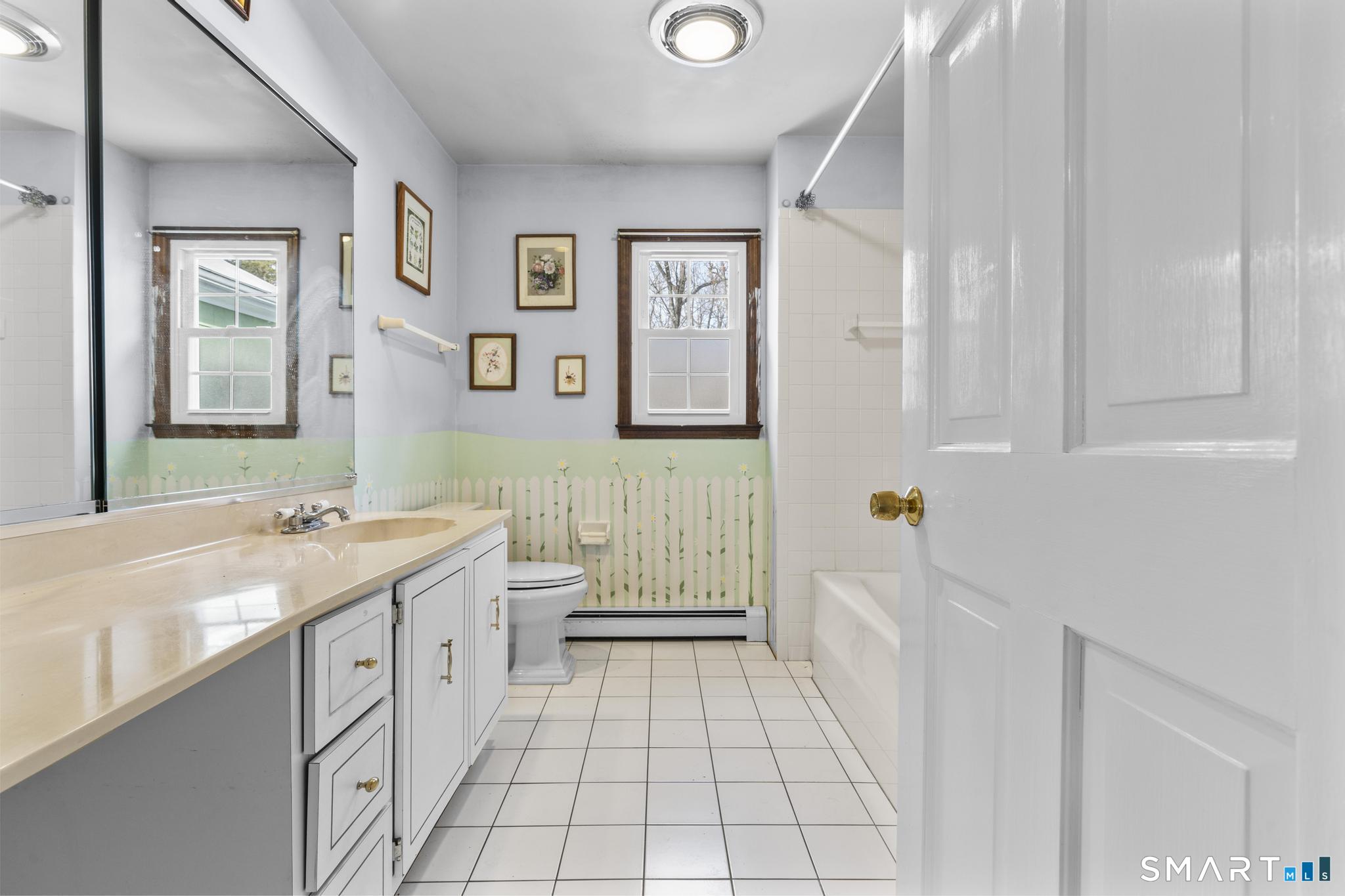 4 Twist Hill Road Newtown, CT 06470 - Photo 24 of 40 a bathroom with a sink a vanity and a bathtub