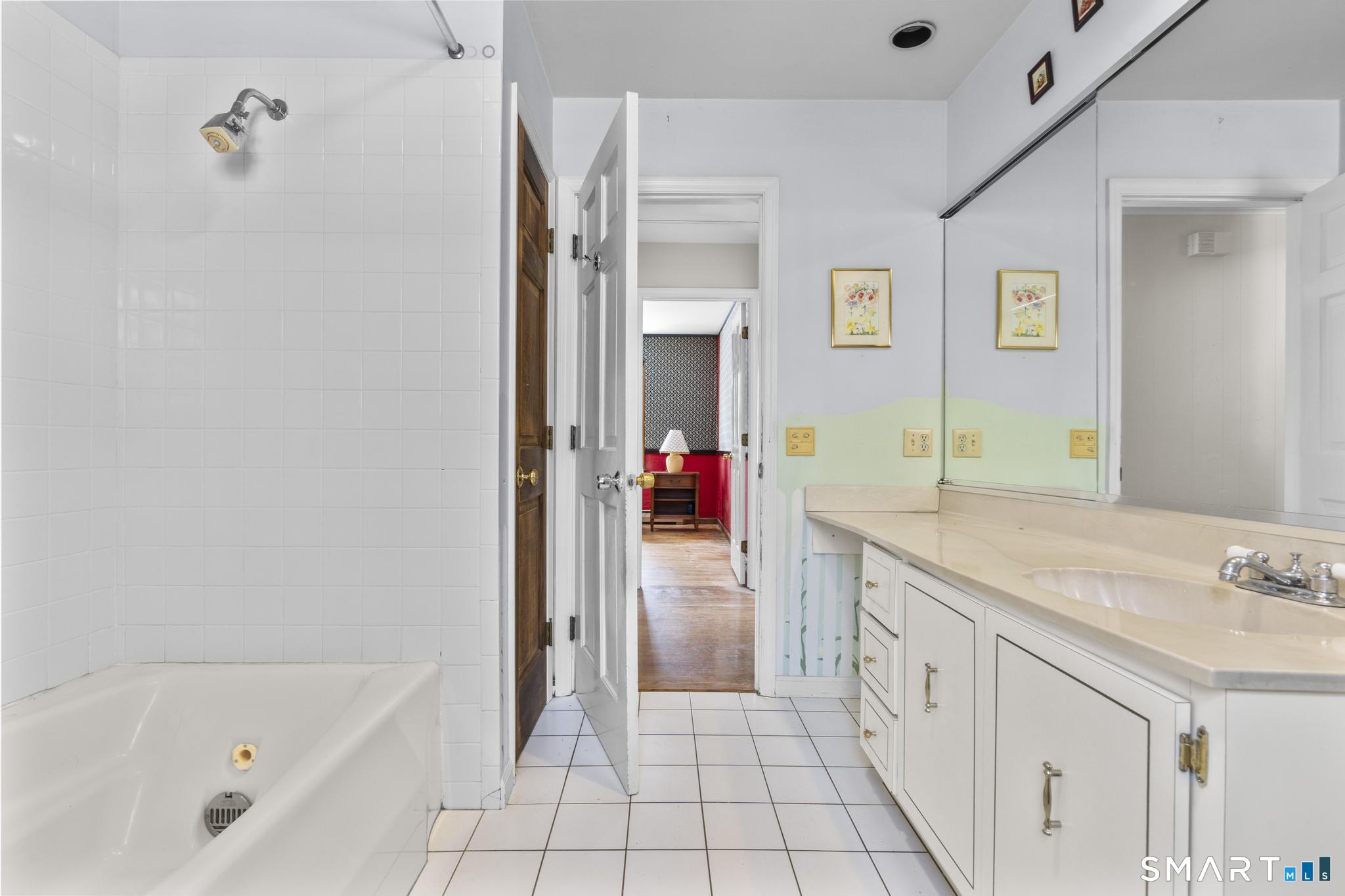 4 Twist Hill Road Newtown, CT 06470 - Photo 25 of 40 a bathroom with a tub sink and mirror