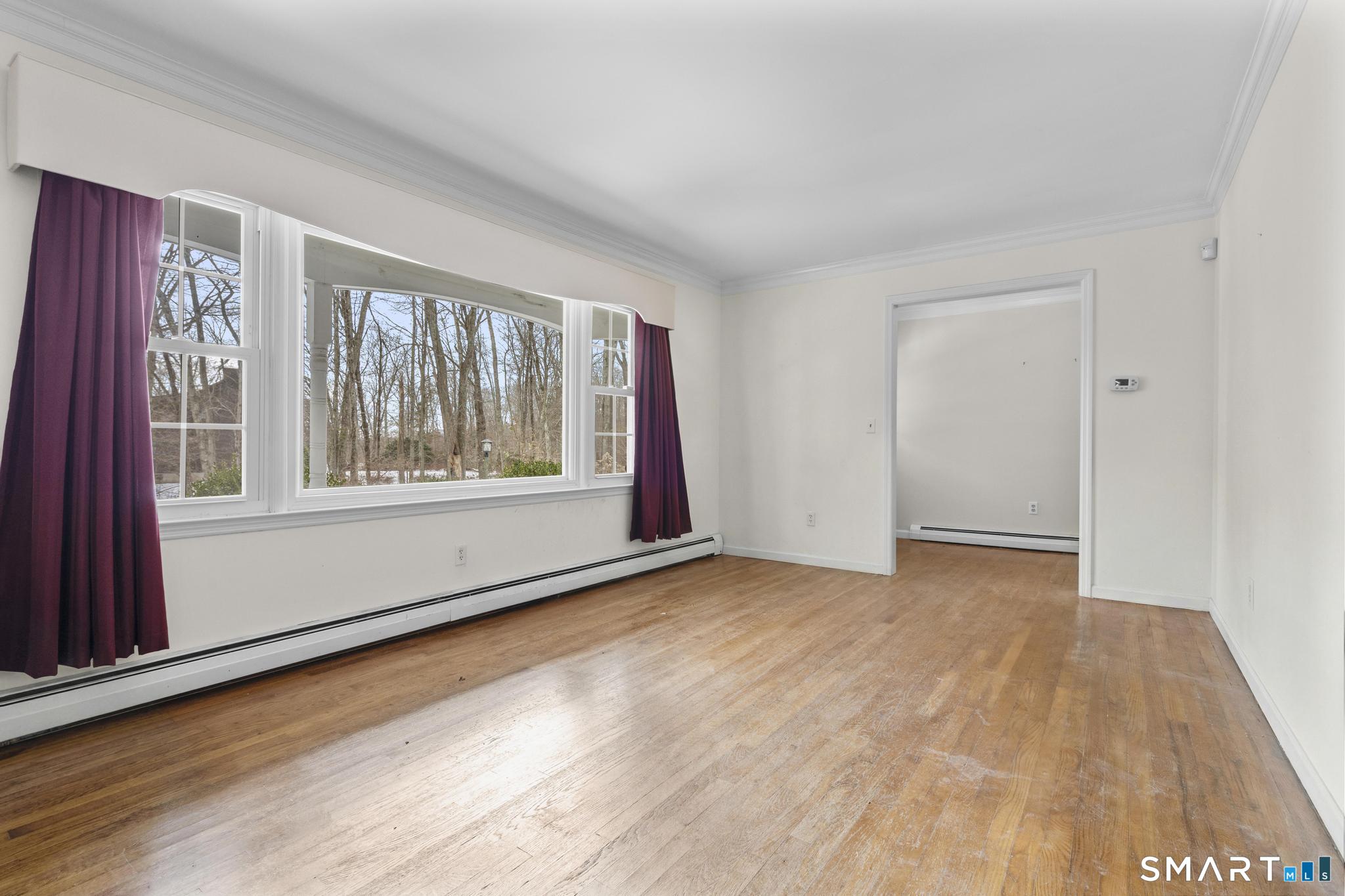 4 Twist Hill Road Newtown, CT 06470 - Photo 5 of 40 a view of an empty room with wooden floor and a window