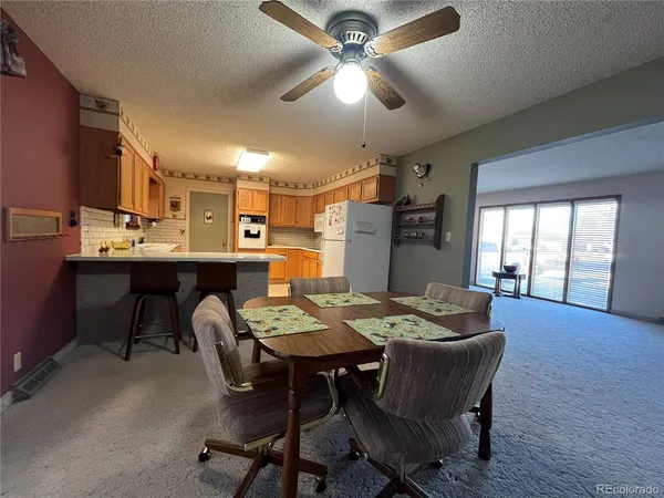 a dining room with a wooden table and chairs