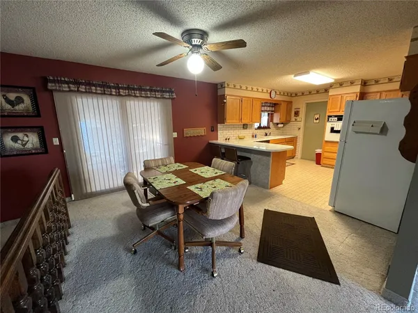 a view of a dining room with furniture and window