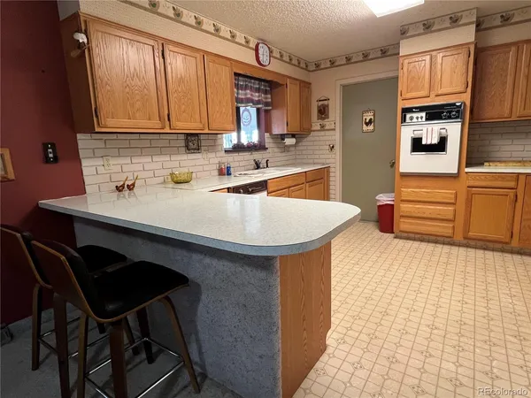 a kitchen with granite countertop a sink and cabinets
