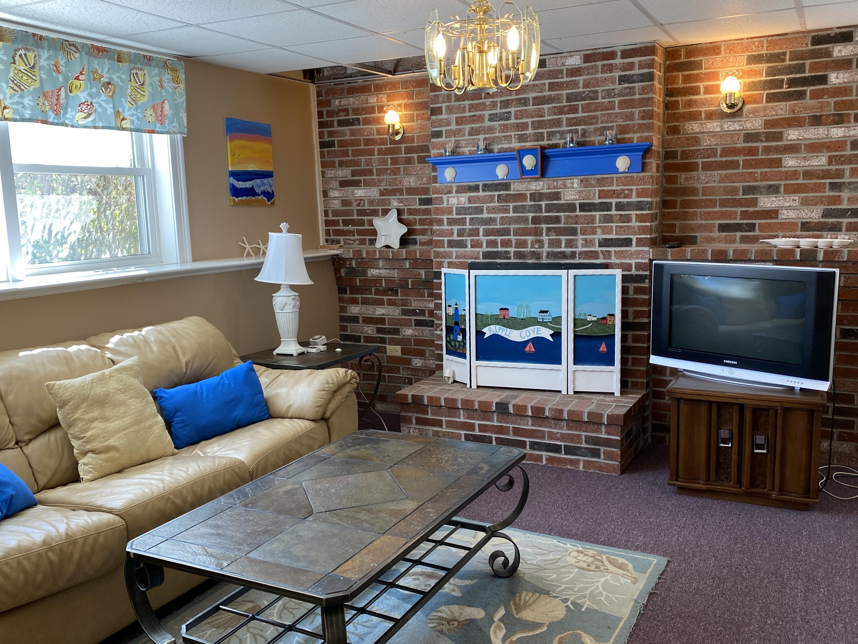 25 Ripple Cove Road Hyannis, MA 02601 - Photo 22 of 38 a living room with furniture and a flat screen tv