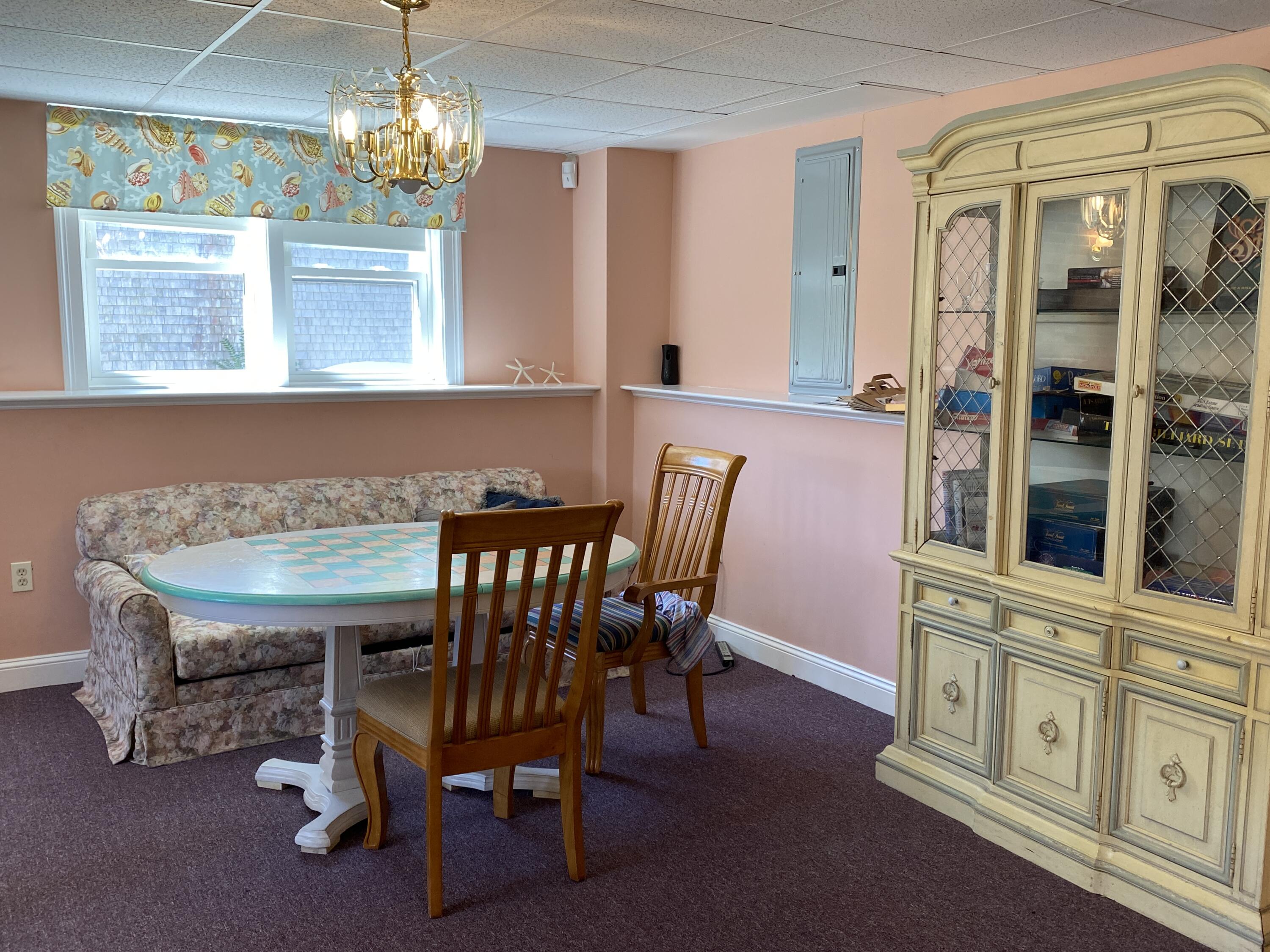 25 Ripple Cove Road Hyannis, MA 02601 - Photo 23 of 38 a view of a dining room with furniture a chandelier and window