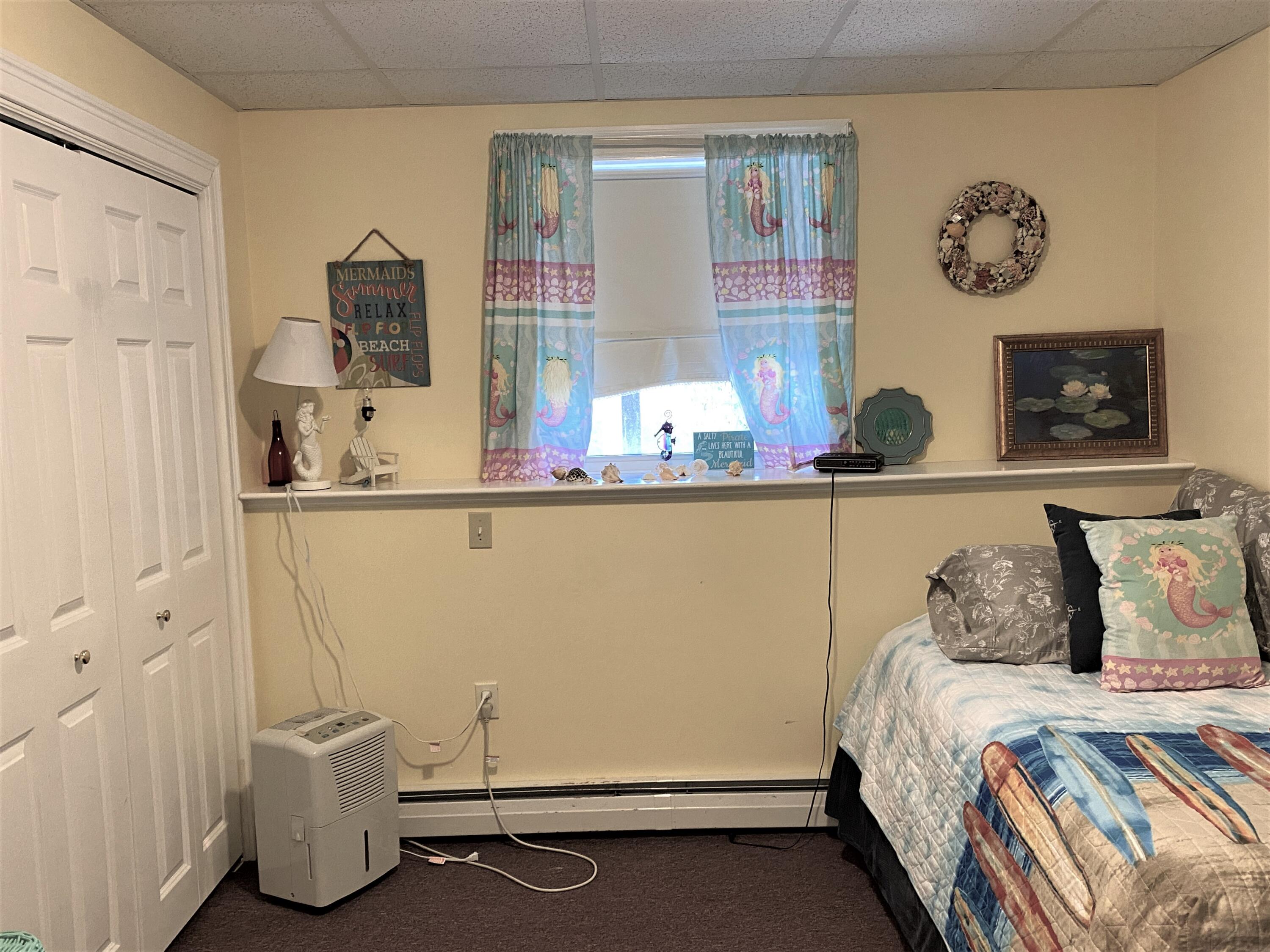 25 Ripple Cove Road Hyannis, MA 02601 - Photo 29 of 38 a room with a wooden floor and table