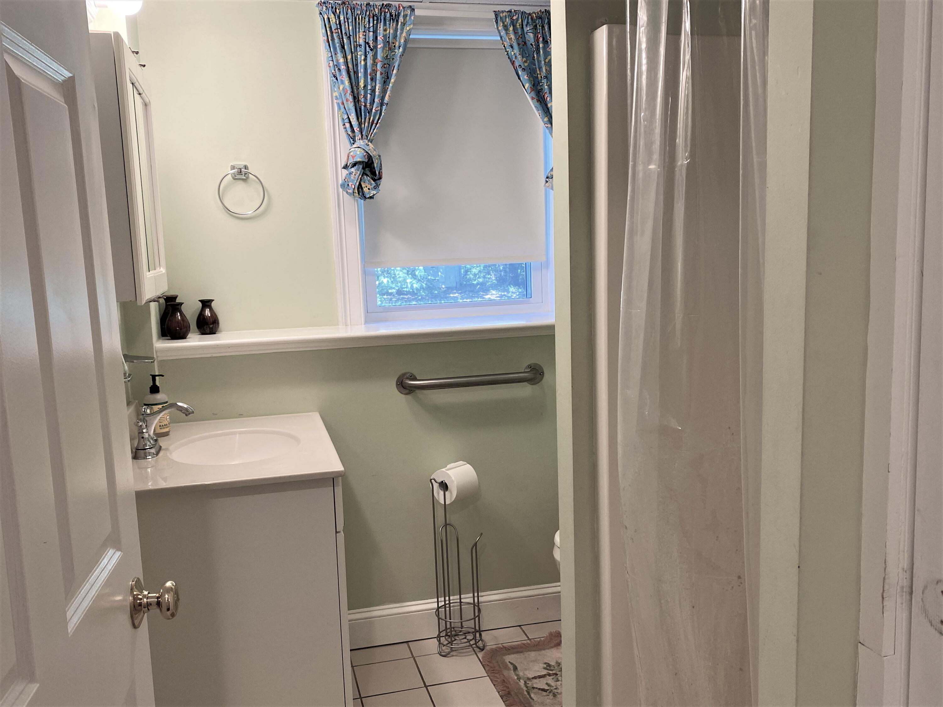 25 Ripple Cove Road Hyannis, MA 02601 - Photo 32 of 38 a bathroom with a sink and mirror with bathtub