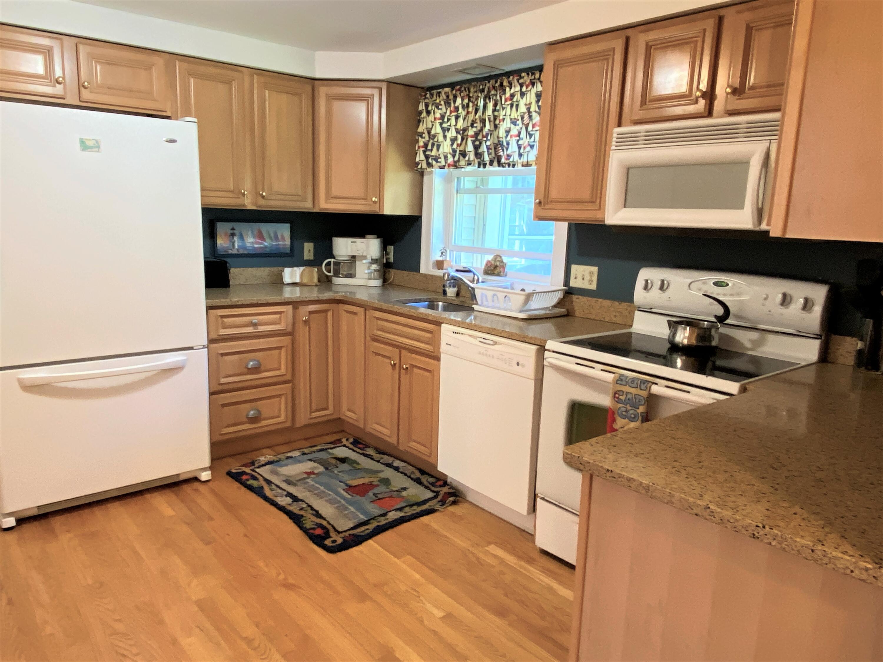 25 Ripple Cove Road Hyannis, MA 02601 - Photo 5 of 38 a kitchen with a stove a sink and a refrigerator
