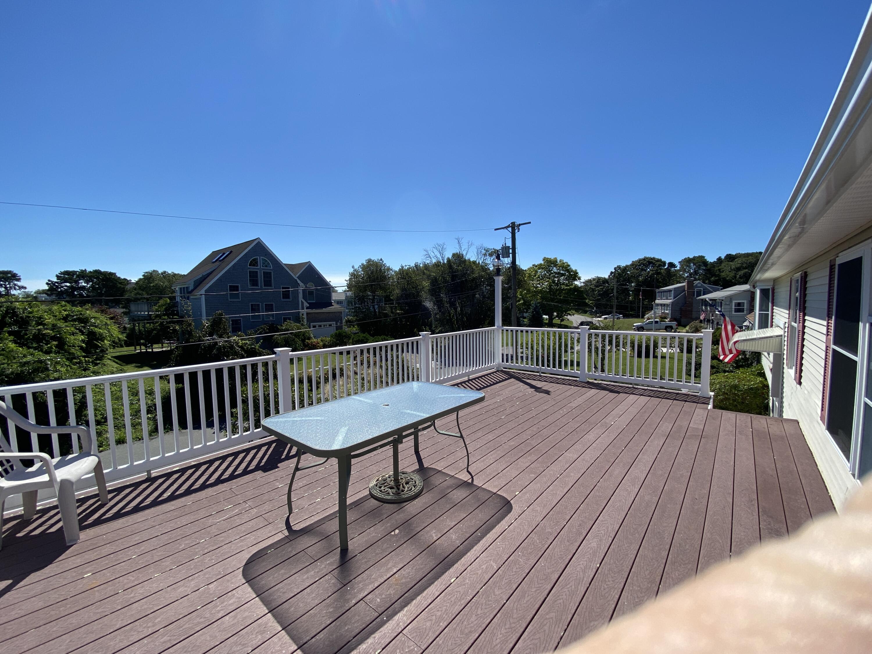 25 Ripple Cove Road Hyannis, MA 02601 - Photo 9 of 38 a view of a wooden deck with a bench
