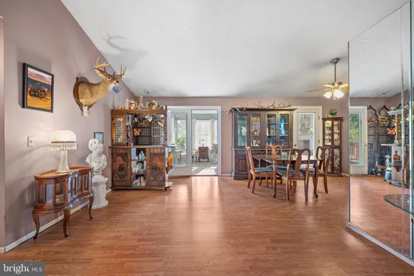 a living room with furniture a flat screen tv and a large window