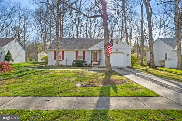 a front view of house with yard and trees