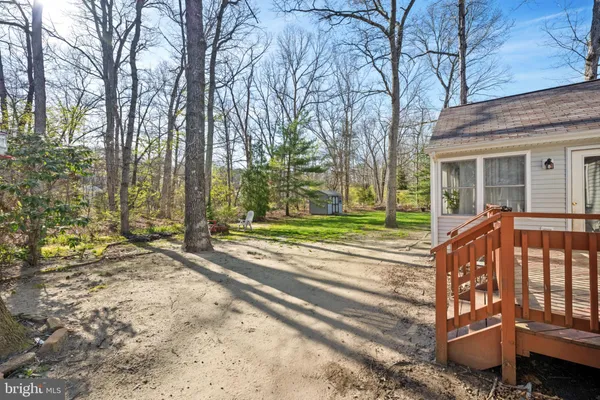 a view of a house with a yard patio and wooden fence