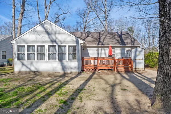 a view of a house with a yard and sitting area