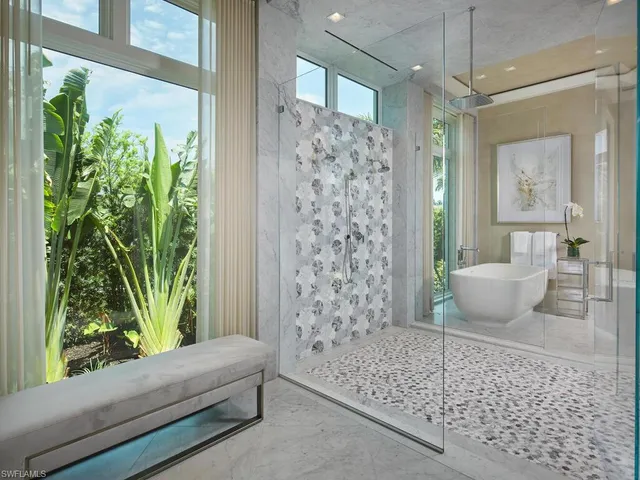 a living room with a couch and a potted plant