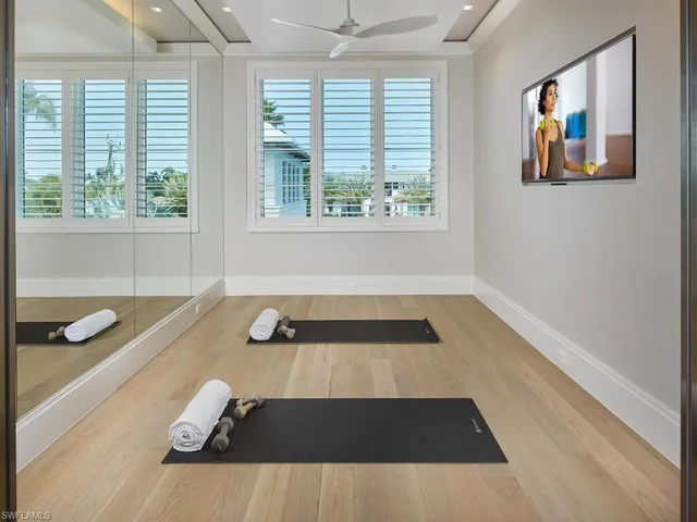 a bedroom with a bed lamp and a large mirror