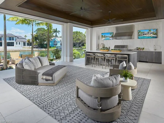 a kitchen with stainless steel appliances granite countertop a coffee maker a sink and white cabinets