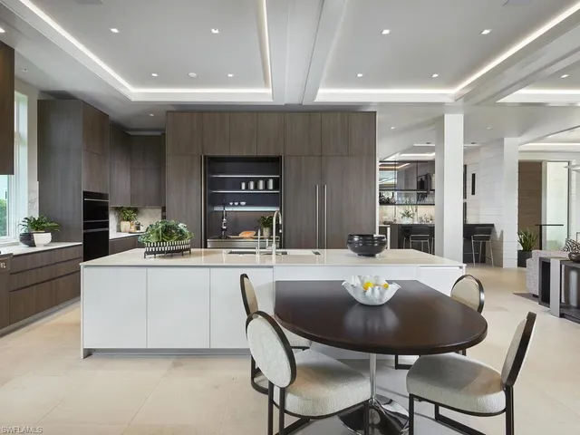a kitchen with a dining table and chairs