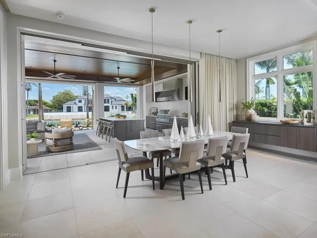 a dining area with furniture and a large window