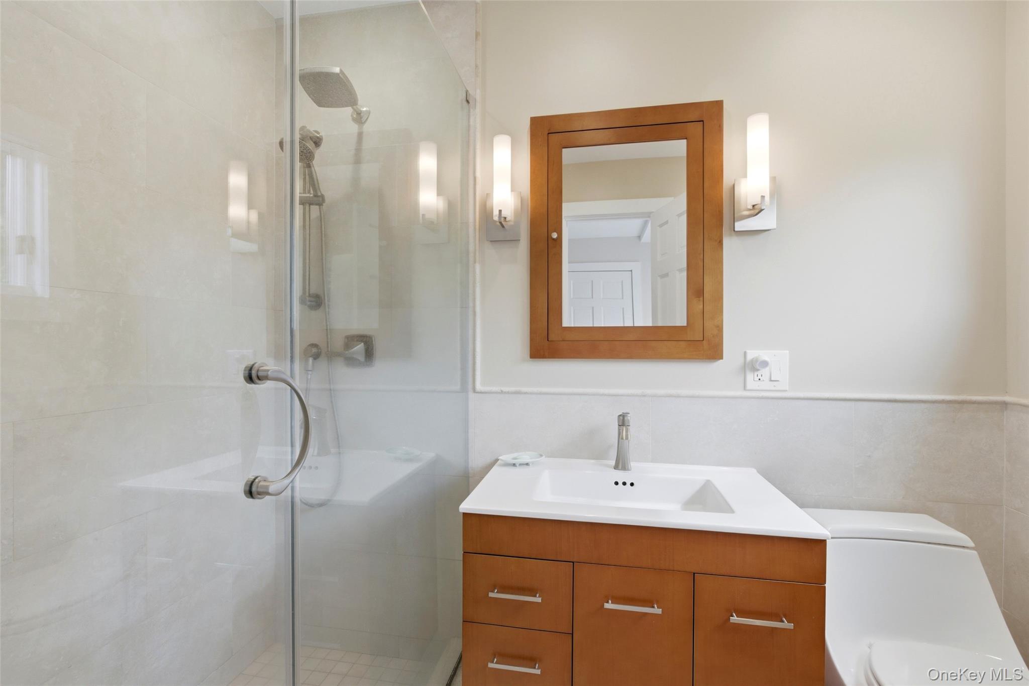 7 Gun Path Setauket, NY 11733 - Photo 20 of 34 a bathroom with a sink a light fixture and a toilet