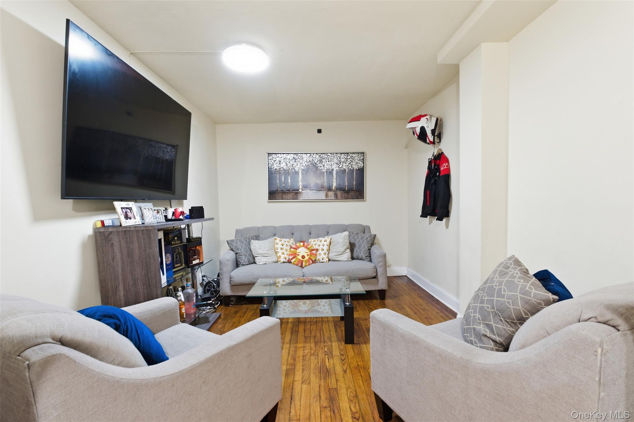 1408 Astor Avenue Bronx, NY 10469 - Photo 15 of 21 2nd floor Unit. Living area featuring hardwood / wood-style flooring and baseboards