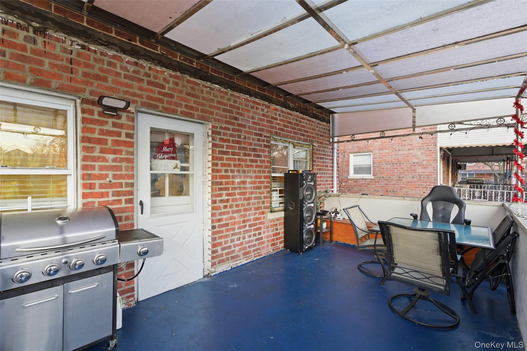 1408 Astor Avenue Bronx, NY 10469 - Photo 19 of 21 Back porch with awnings with area for grilling, outdoor dining area, and a pergola