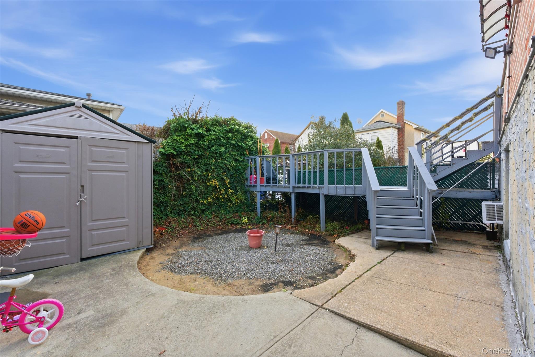 1408 Astor Avenue Bronx, NY 10469 - Photo 20 of 21 View of patio featuring stairs, a storage shed, and a wooden deck