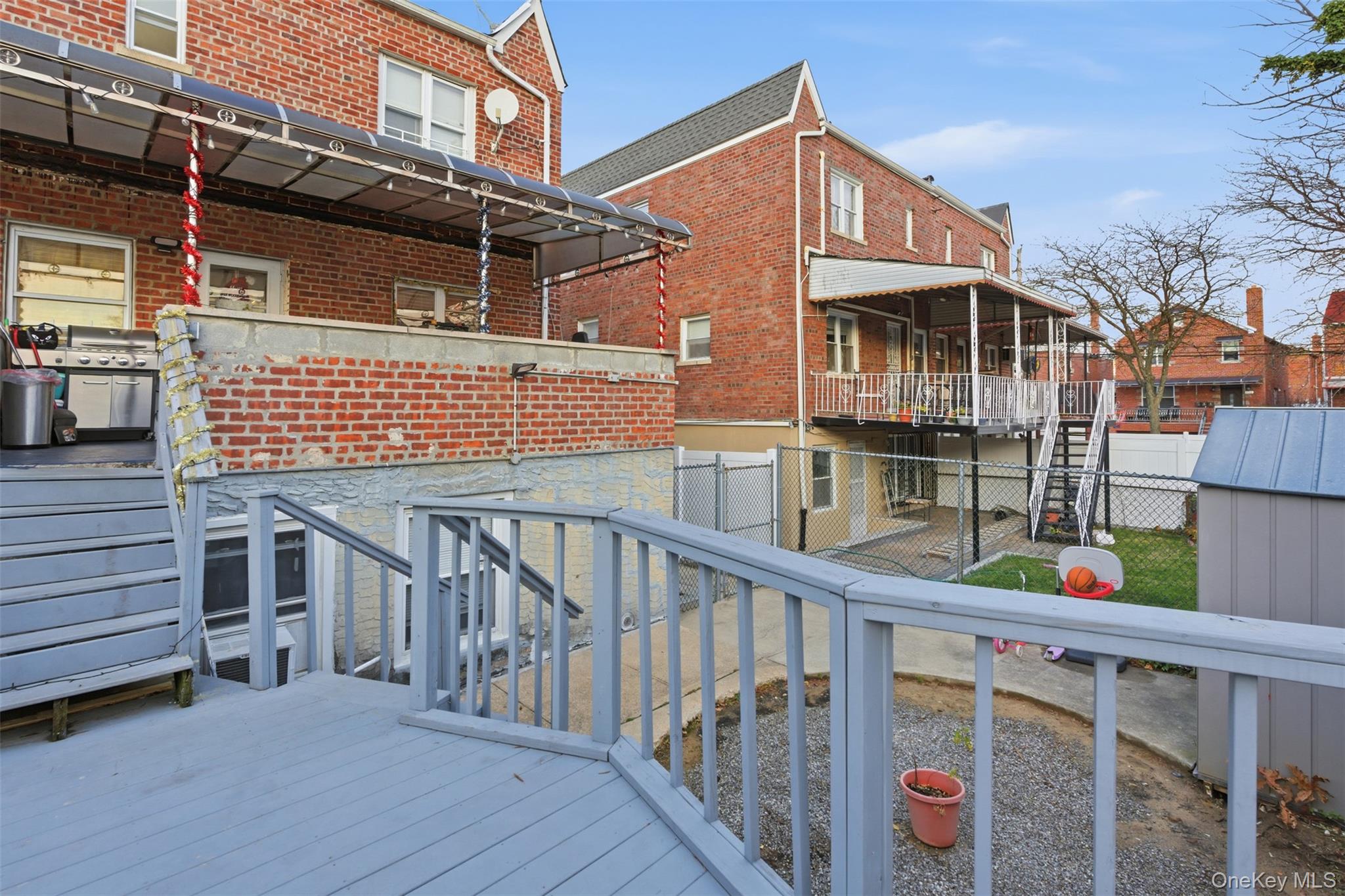 1408 Astor Avenue Bronx, NY 10469 - Photo 21 of 21 Deck featuring stairway, a fenced backyard, and a residential view