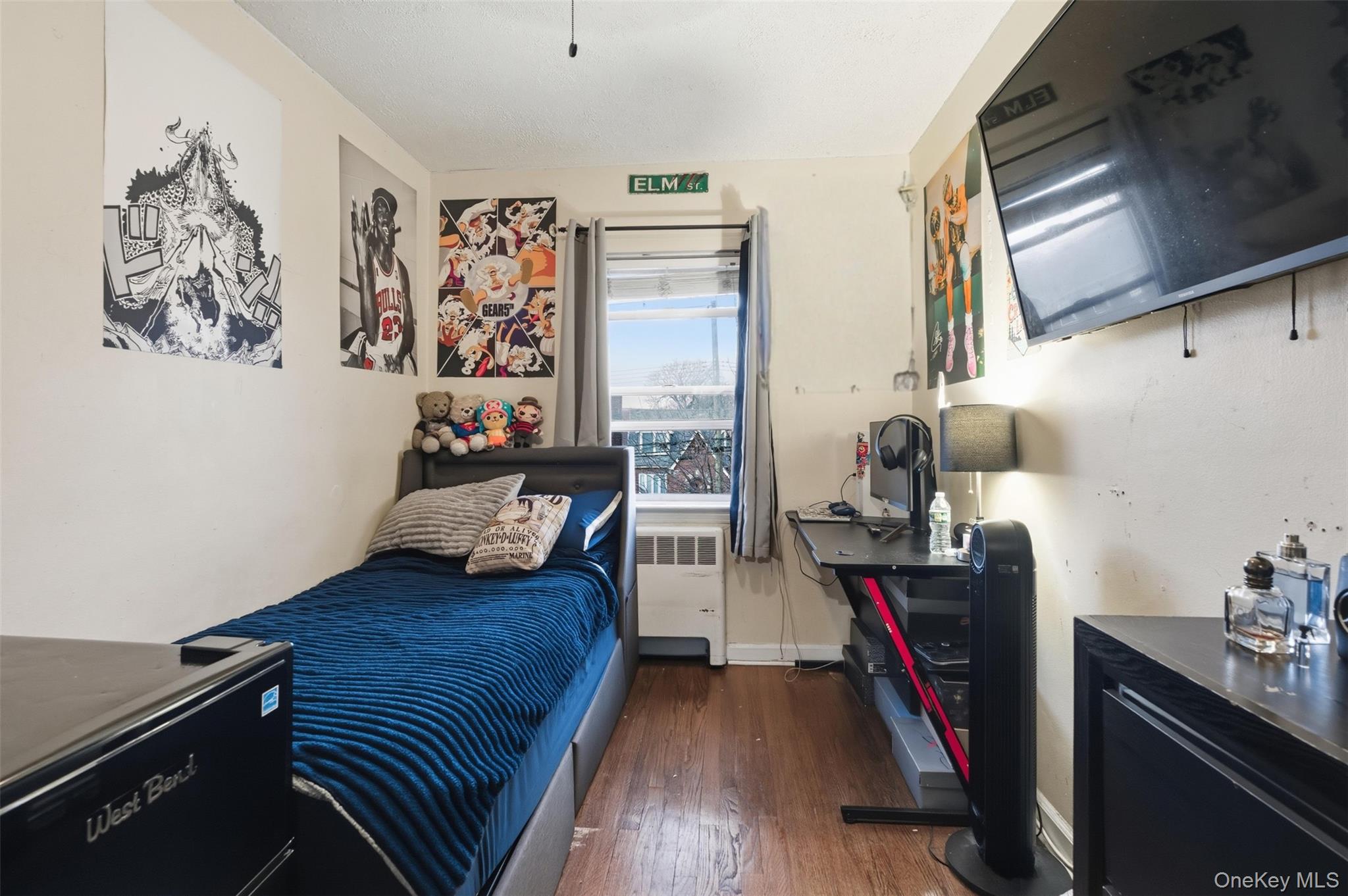 1408 Astor Avenue Bronx, NY 10469 - Photo 10 of 21 Bedroom with radiator heating unit and dark wood-type flooring