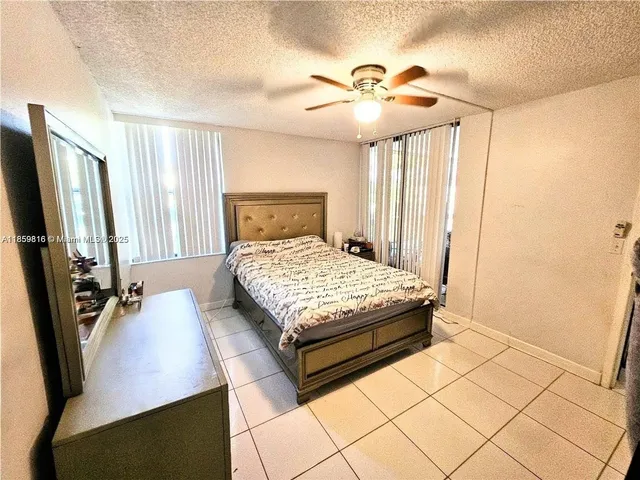a bedroom with a bed lamps and a large mirror