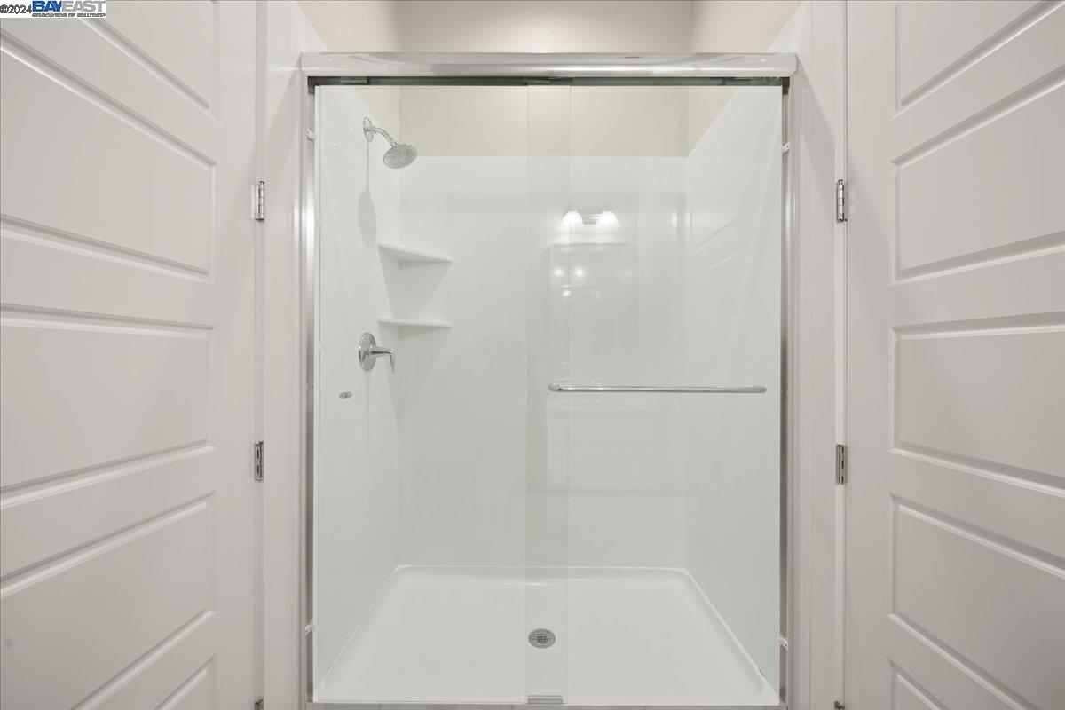 2969 Delamar Drive Dublin, CA 94568 - Photo 17 of 27 a bathroom with a glass shower door
