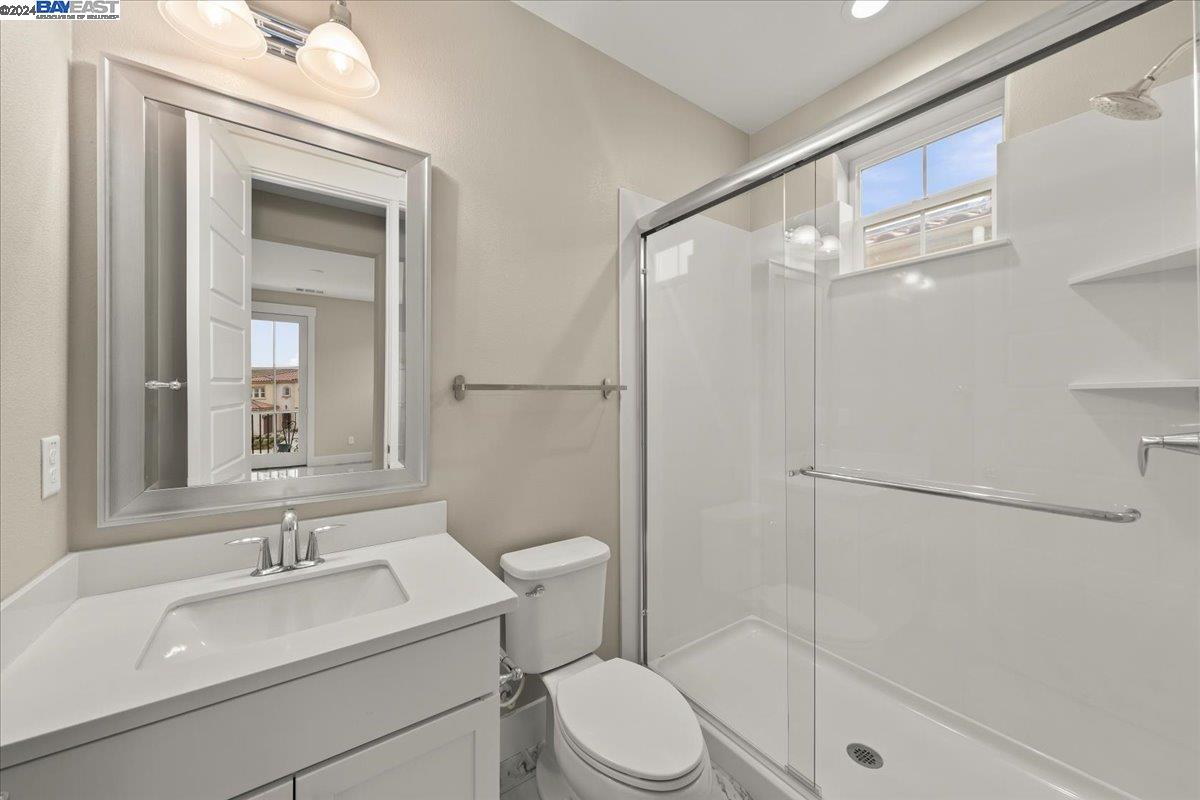 2969 Delamar Drive Dublin, CA 94568 - Photo 20 of 27 a bathroom with a sink toilet vanity and shower