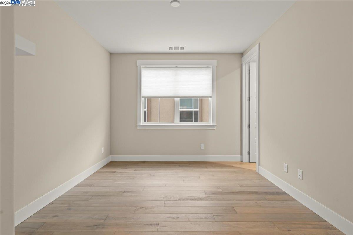 2969 Delamar Drive Dublin, CA 94568 - Photo 22 of 27 an empty room with wooden floor and windows