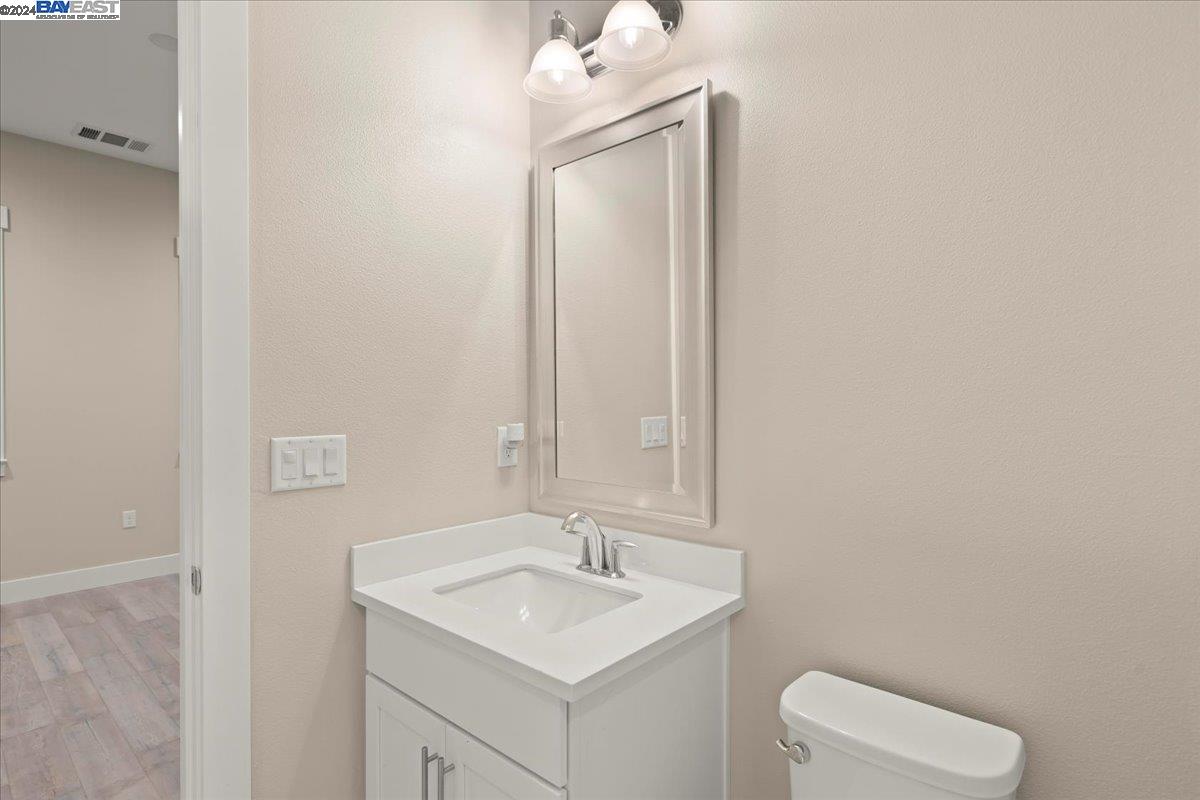 2969 Delamar Drive Dublin, CA 94568 - Photo 23 of 27 a bathroom with a toilet sink and mirror