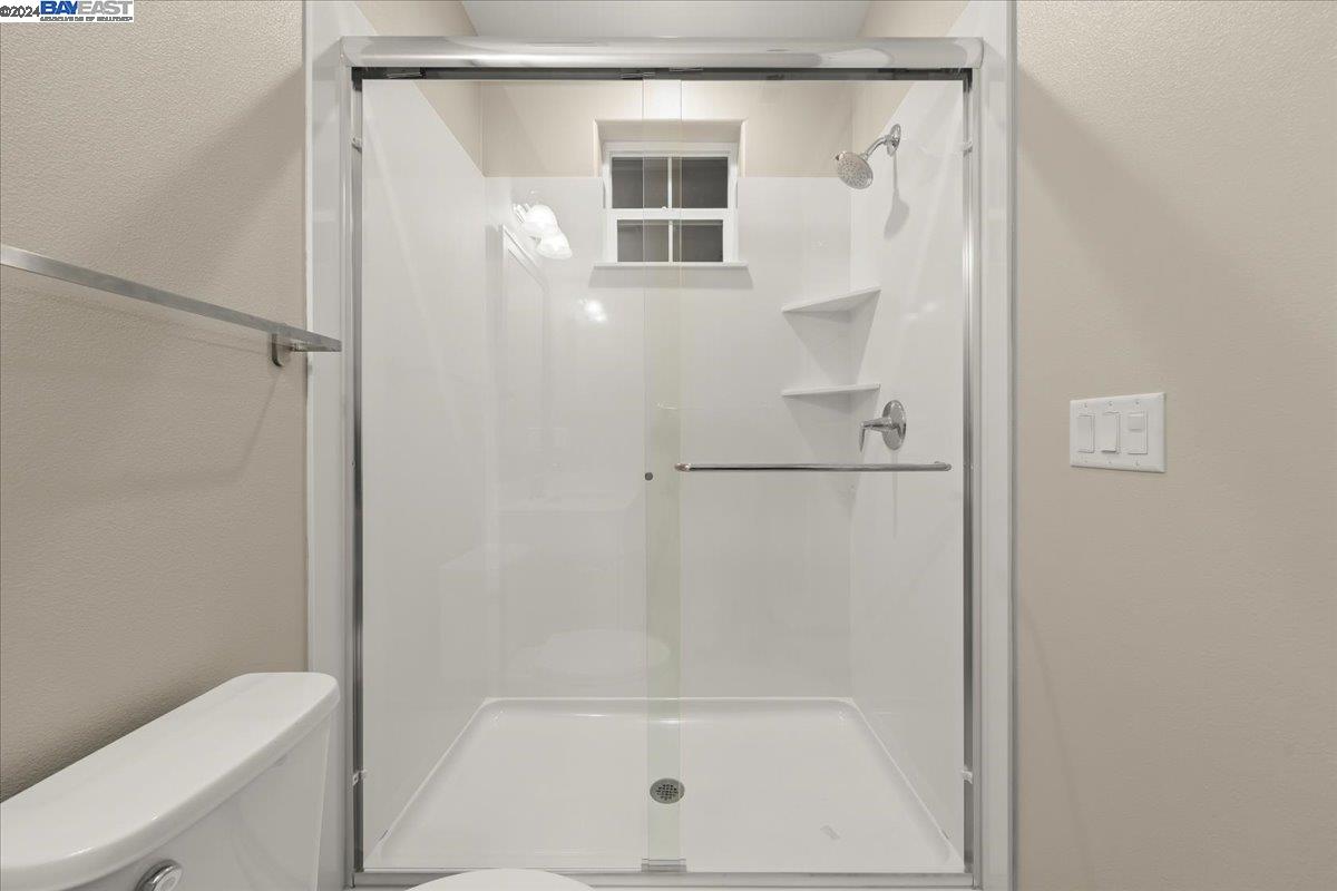 2969 Delamar Drive Dublin, CA 94568 - Photo 24 of 27 a bathroom with a glass shower door