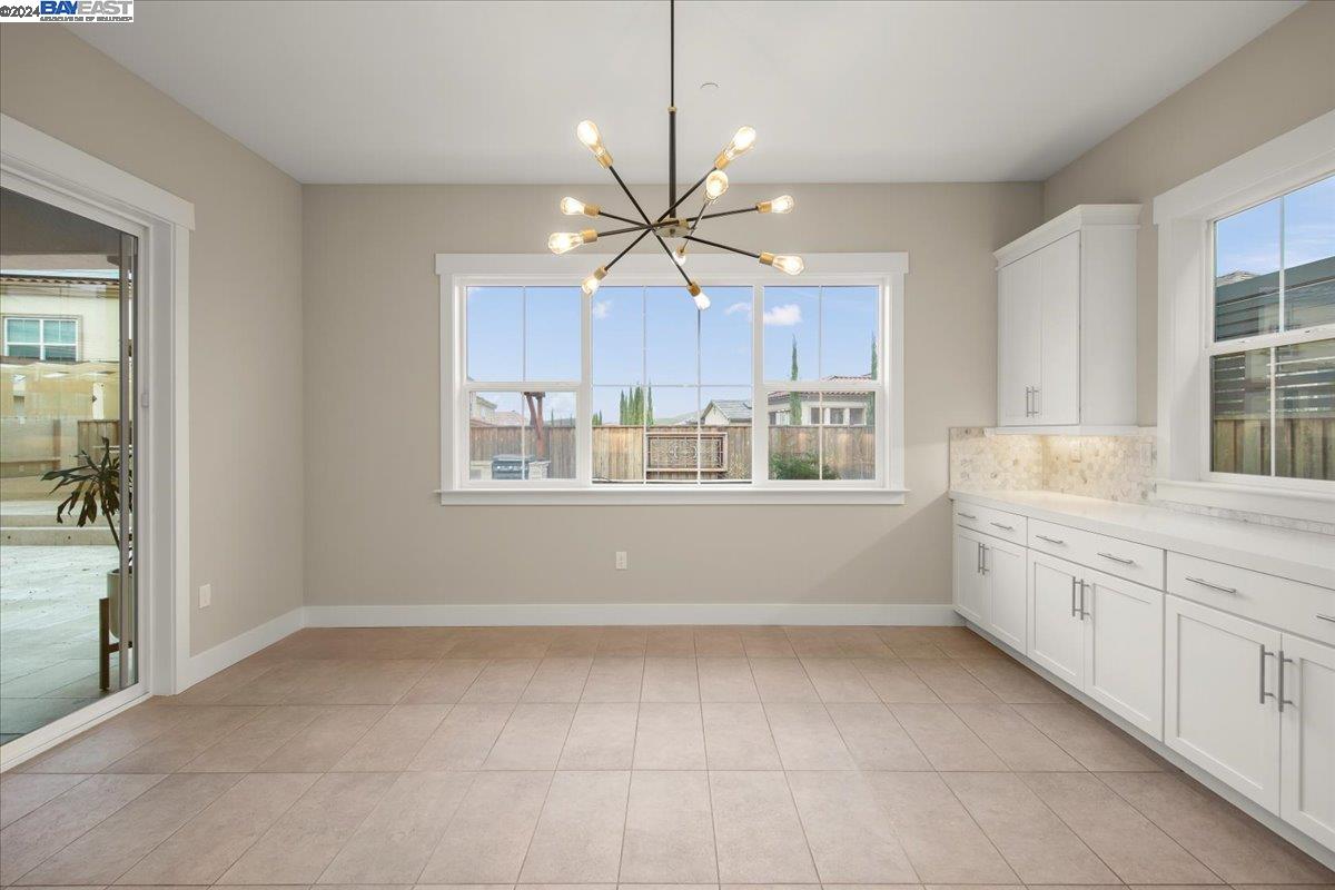 2969 Delamar Drive Dublin, CA 94568 - Photo 6 of 27 a kitchen with stainless steel appliances a window and a chandelier