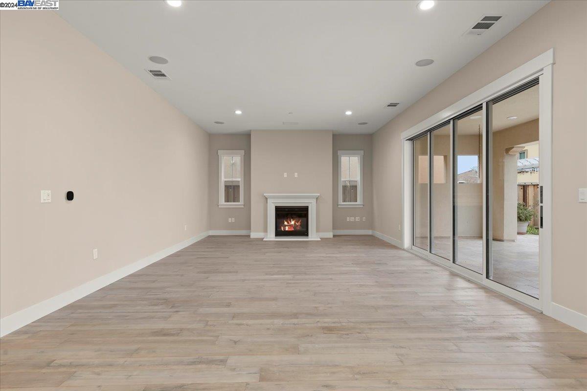 2969 Delamar Drive Dublin, CA 94568 - Photo 8 of 27 a view of an empty room with a fireplace and a window