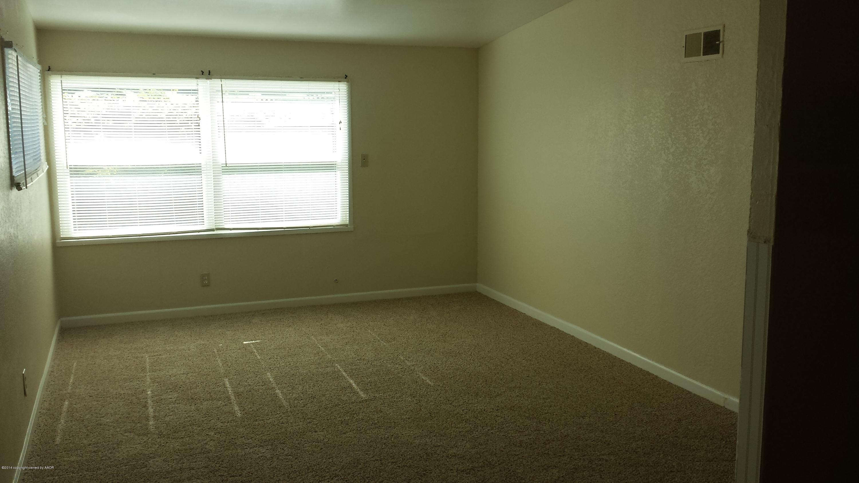 4420 South Hayden Street Amarillo, TX 79110 - Photo 3 of 16 a view of an empty room with a window