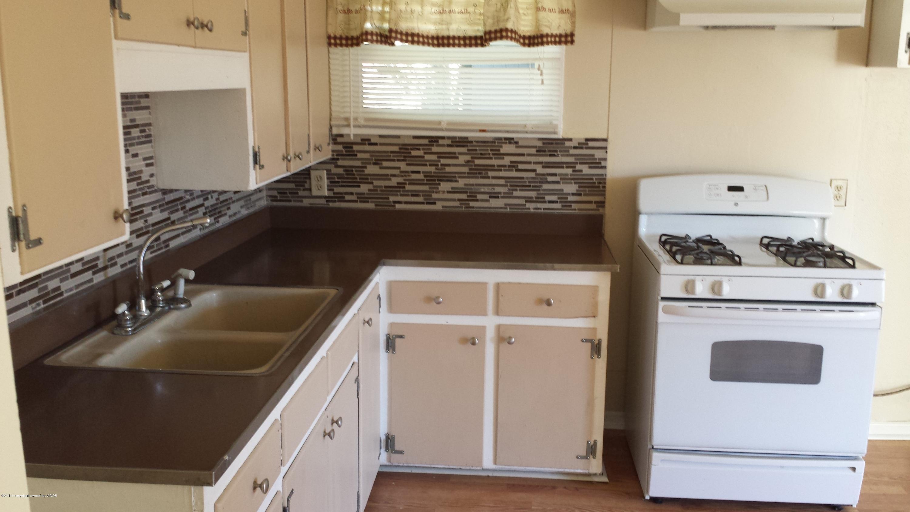 4420 South Hayden Street Amarillo, TX 79110 - Photo 5 of 16 a kitchen with a stove and a sink