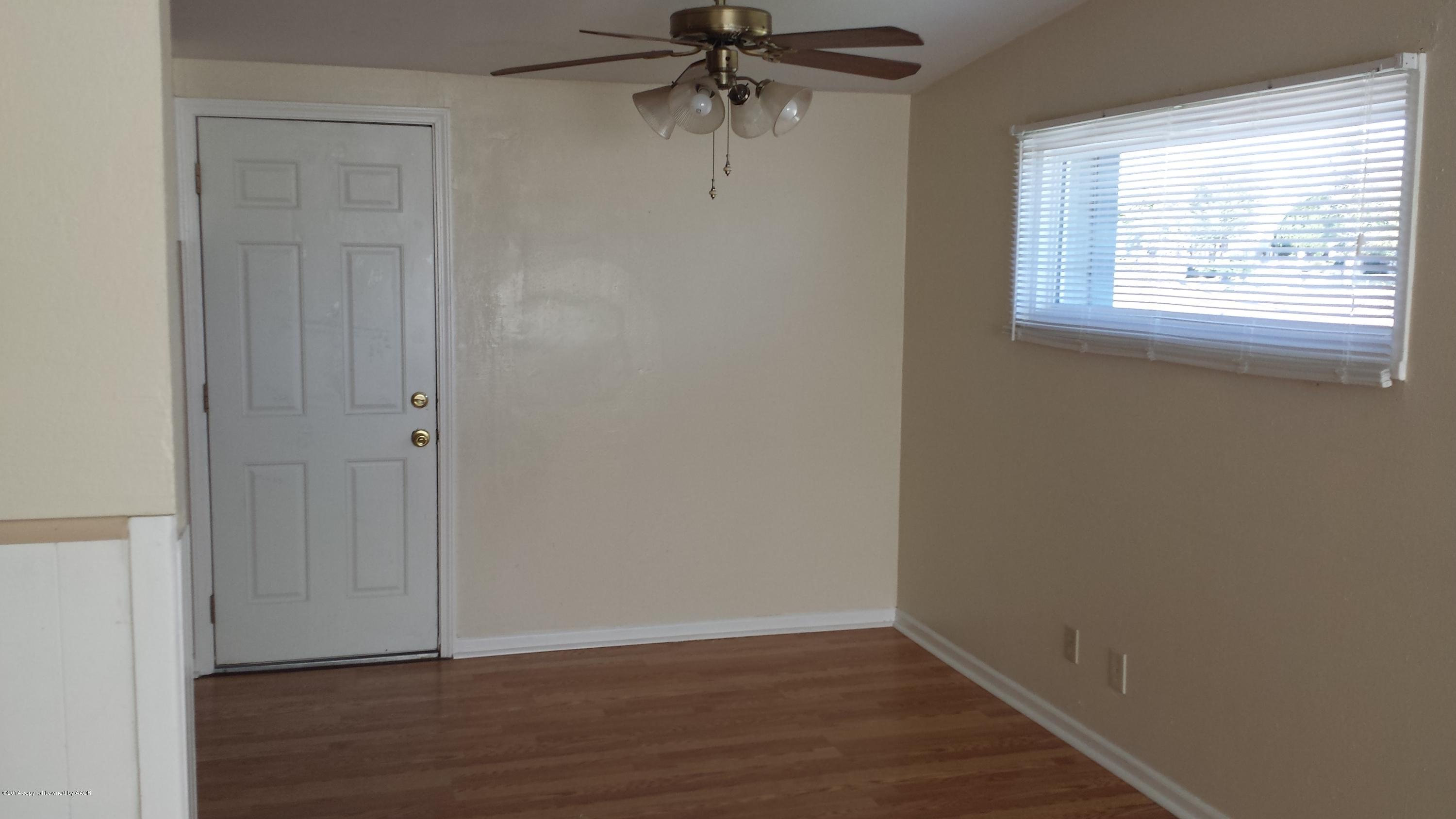 4420 South Hayden Street Amarillo, TX 79110 - Photo 6 of 16 an empty room with wooden floor closet and windows