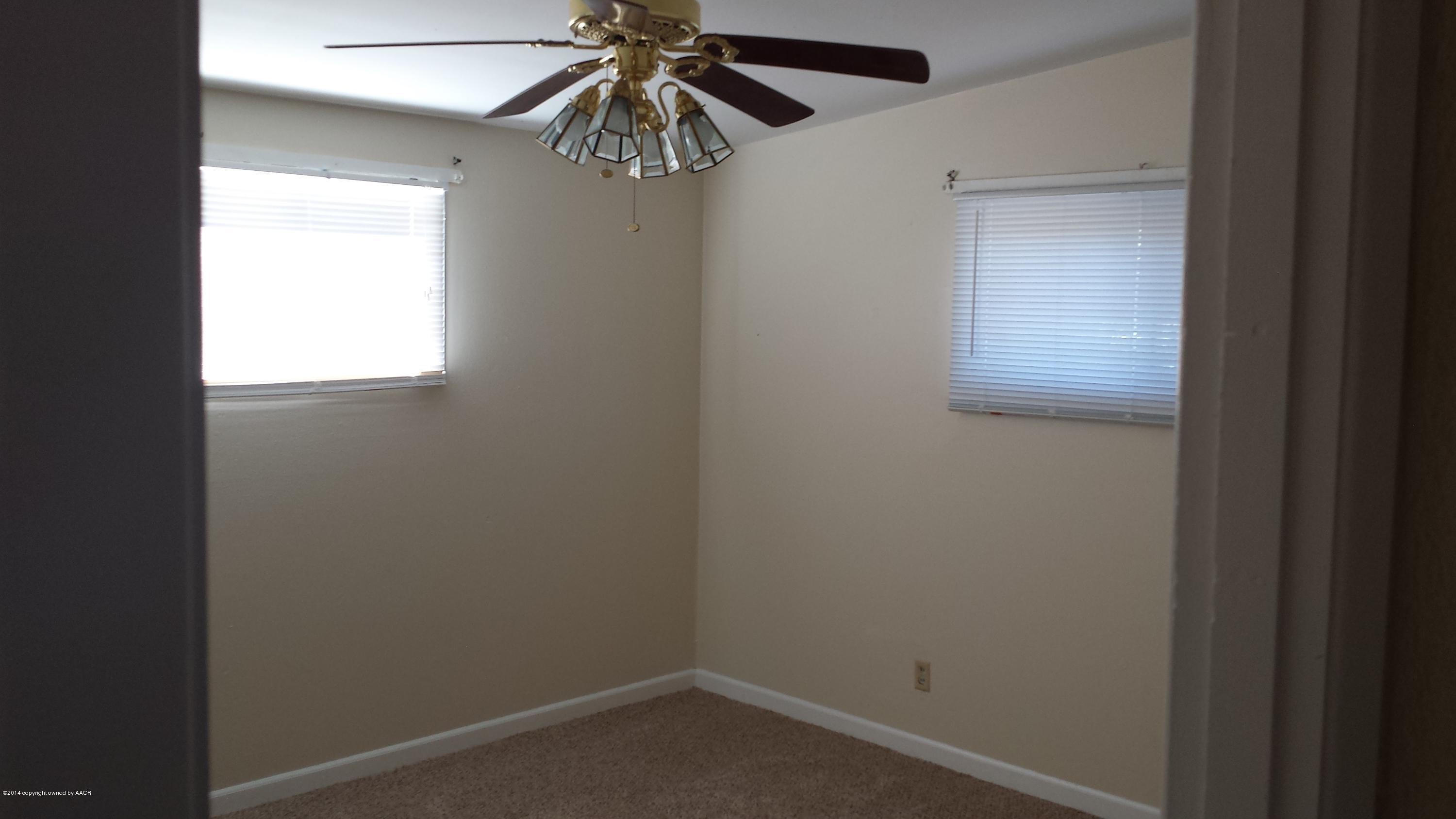 4420 South Hayden Street Amarillo, TX 79110 - Photo 10 of 16 an empty room with a window and a fan